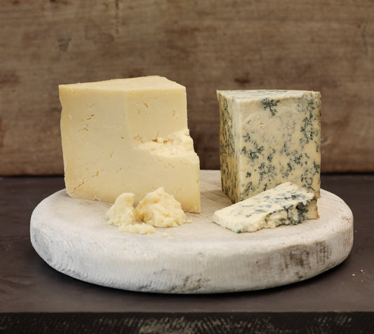 Wedge of Mull Cheese and Hebridean Blue on an old cheese follower
