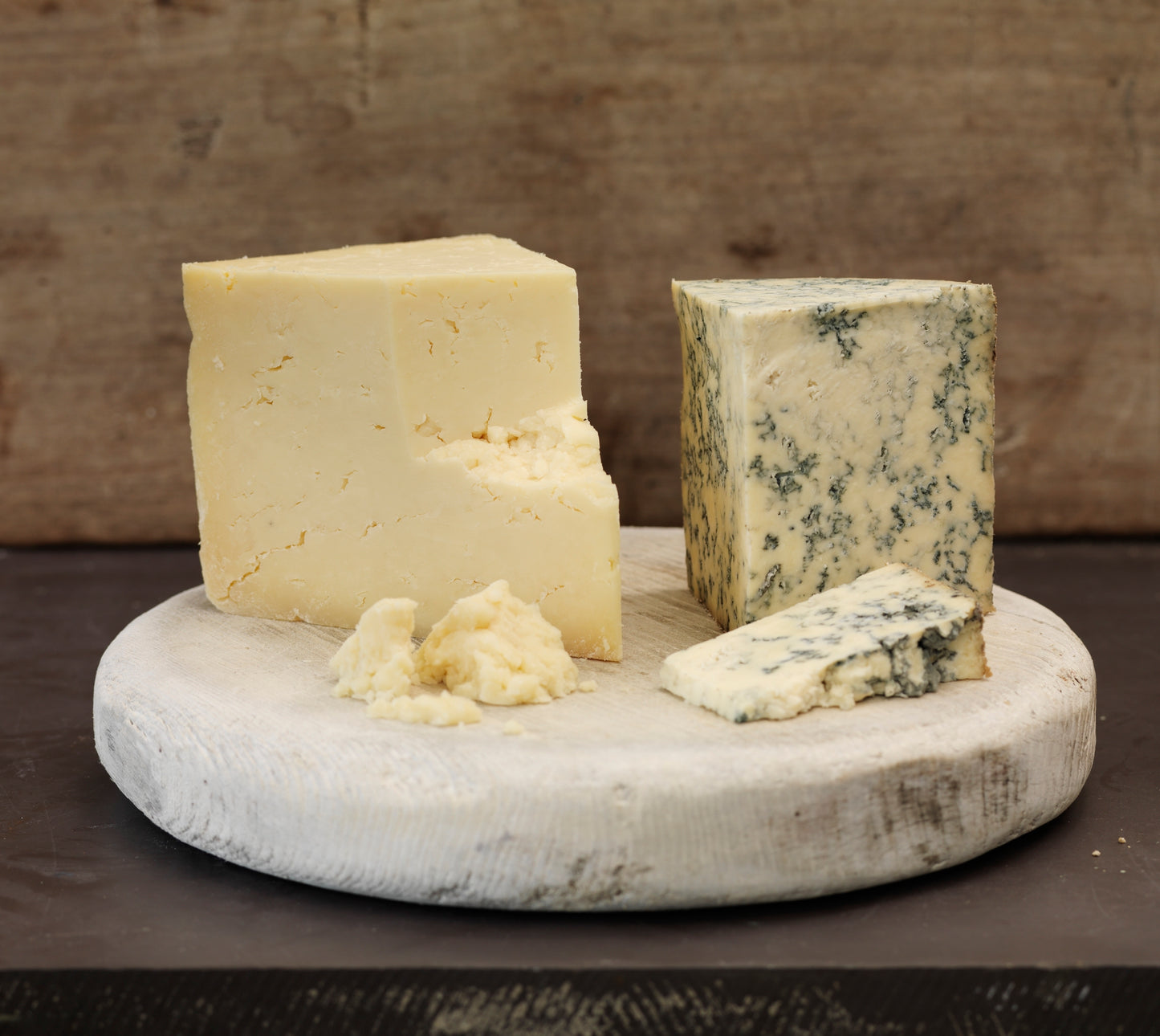 Wedge of Mull Cheese and Hebridean Blue on an old cheese follower